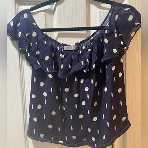 Blue polka dot top with ruffle scoop neck and sheer arms and back